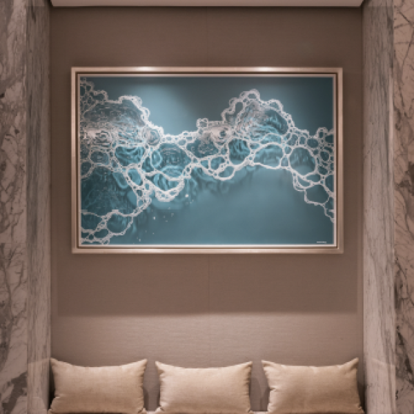 Framed blue and white abstract artwork above a cushioned bench
